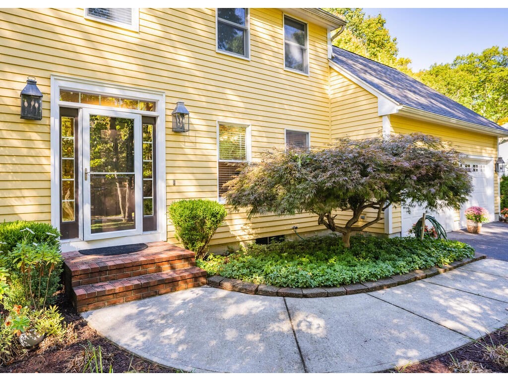 79 Pomeroy Meadow Road Southampton, MA 01073 - Photo 8 of 42 a front view of a house with a yard and potted plants