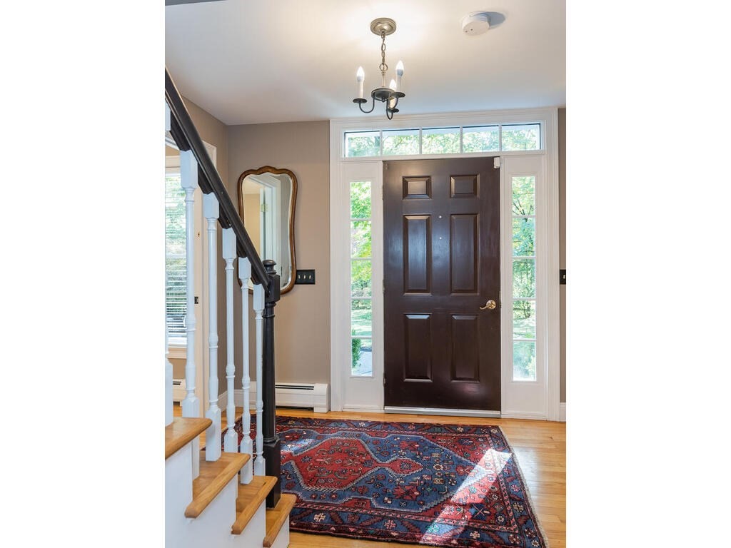 79 Pomeroy Meadow Road Southampton, MA 01073 - Photo 9 of 42 a living room with furniture and a chandelier