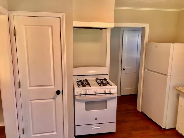 a kitchen with a refrigerator sink stove and cabinets
