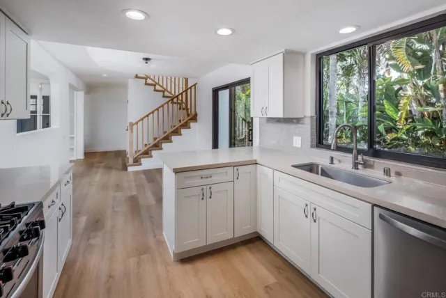 a kitchen with a stove a refrigerator and a sink