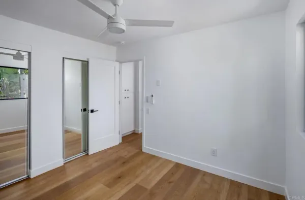 a view of a room with wooden floor and a balcony