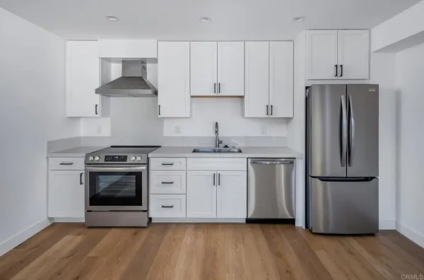 a bathroom with a shower sink vanity mirror and toilet