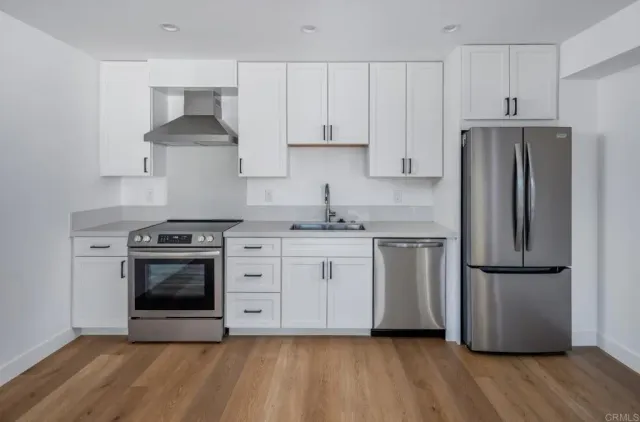 a bathroom with a shower sink vanity mirror and toilet