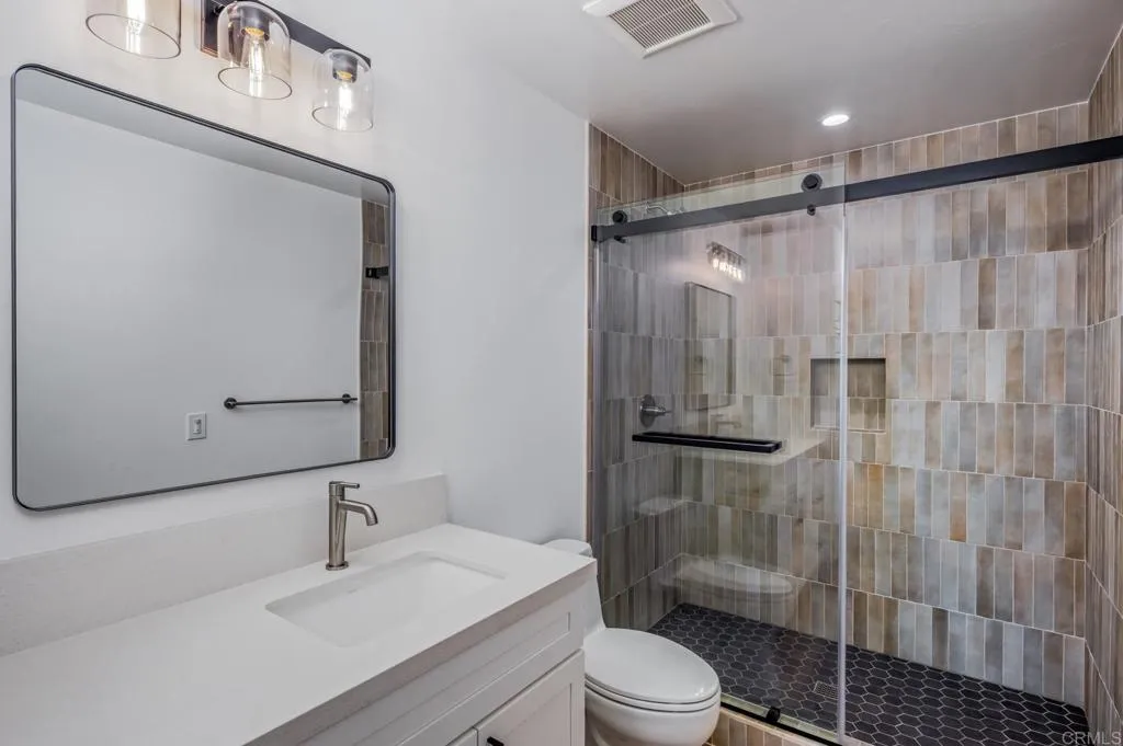 250 Hillcrest Drive Encinitas, CA 92024 - Photo 11 of 54 a bathroom with a sink a toilet and shower