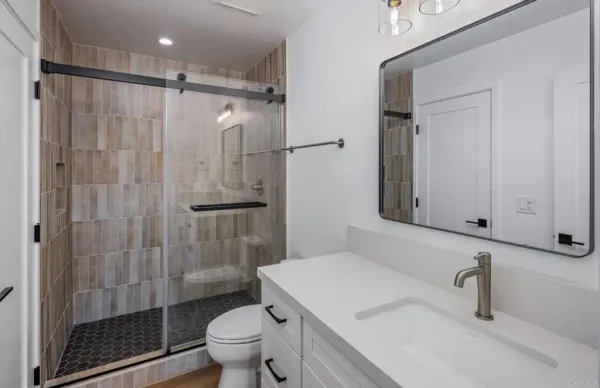a kitchen with granite countertop a refrigerator stove and oven