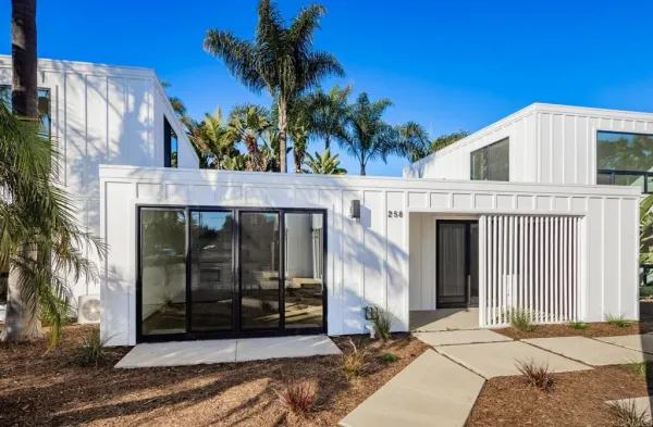 a kitchen with a sink cabinets stainless steel appliances and a large window