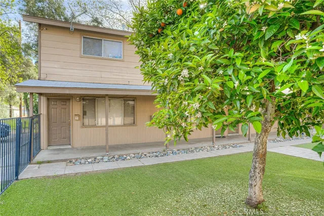 a front view of a house with a garden