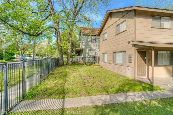 a yellow house with pool in front of it
