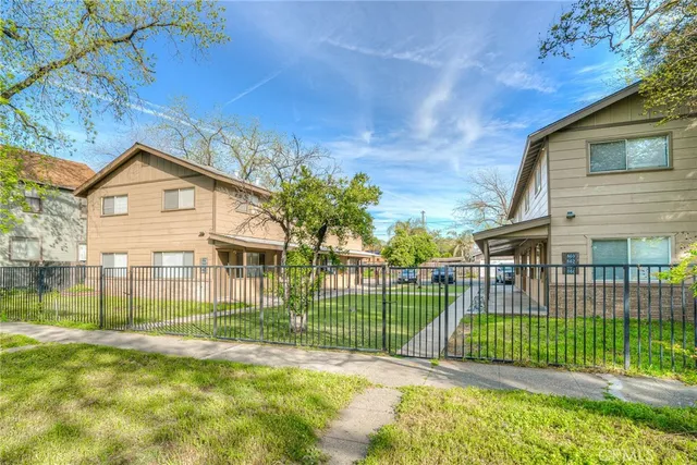 a view of a house with a backyard and a garden