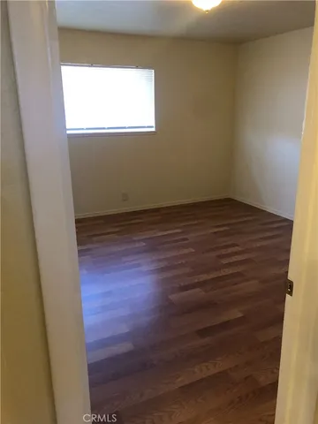 a view of a small space with wooden floor and a window