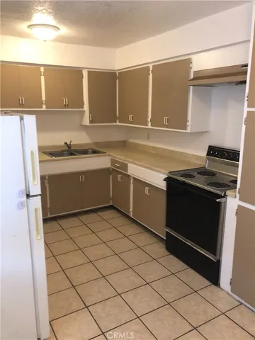 a kitchen with a sink and a stove top oven