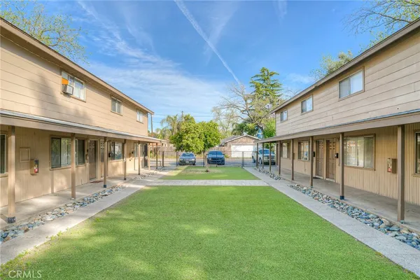 a front view of a house with a yard table and chairs