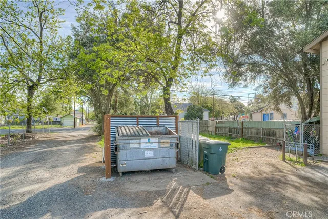 a view of a swimming pool with a bench and trees