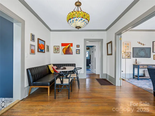 a view of livingroom and dining room with furniture wooden floor and a rug