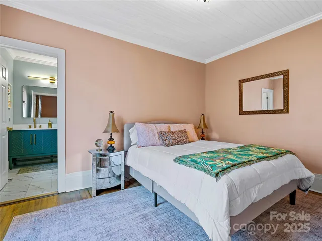 a bedroom with a bed and a mirror