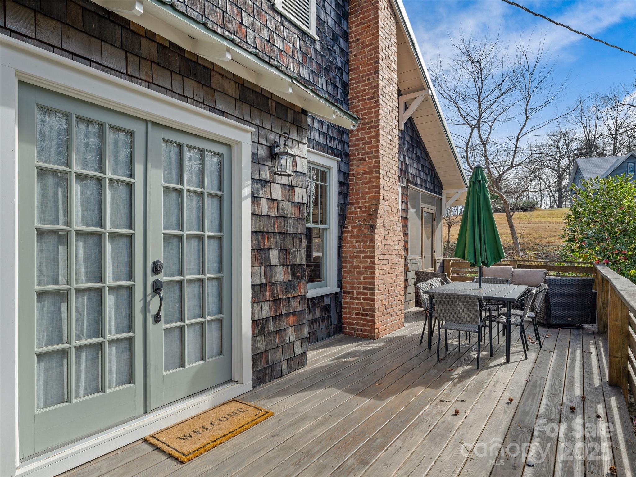 277 Markham Road Tryon, NC 28782 - Photo 24 of 44 a view of a patio with table and chairs and wooden floor