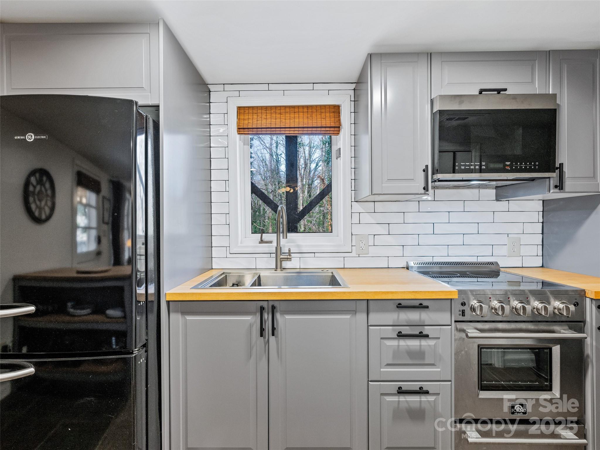 277 Markham Road Tryon, NC 28782 - Photo 33 of 44 a kitchen with a sink and a microwave