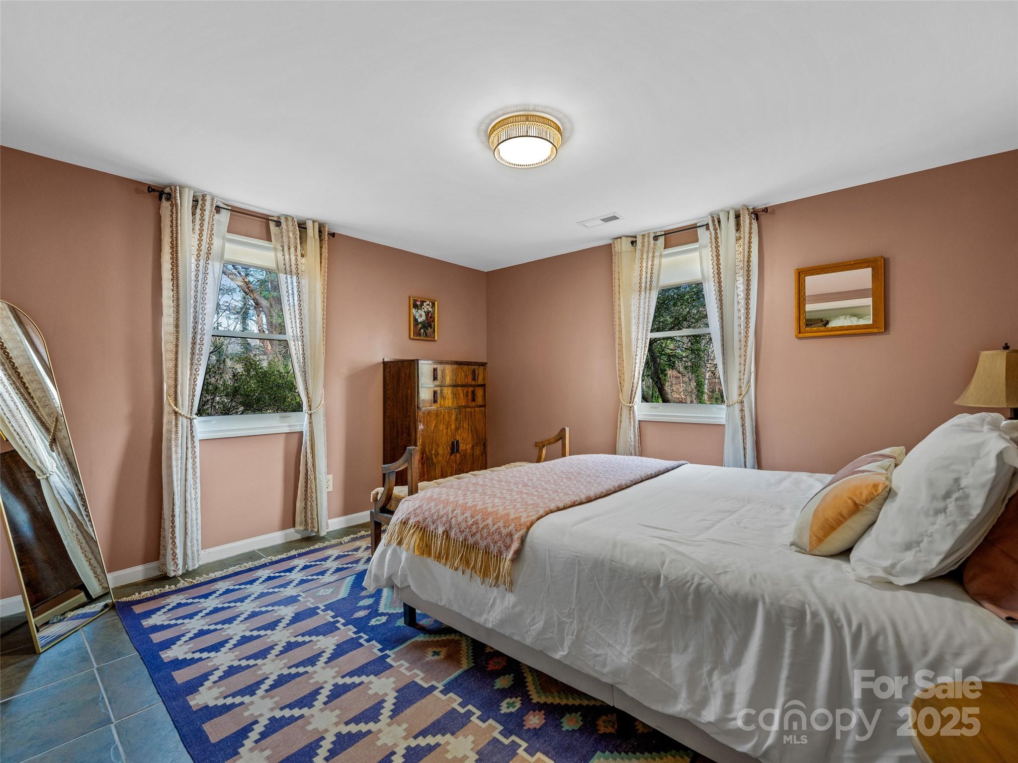 277 Markham Road Tryon, NC 28782 - Photo 34 of 44 a bedroom with a bed and wooden floor