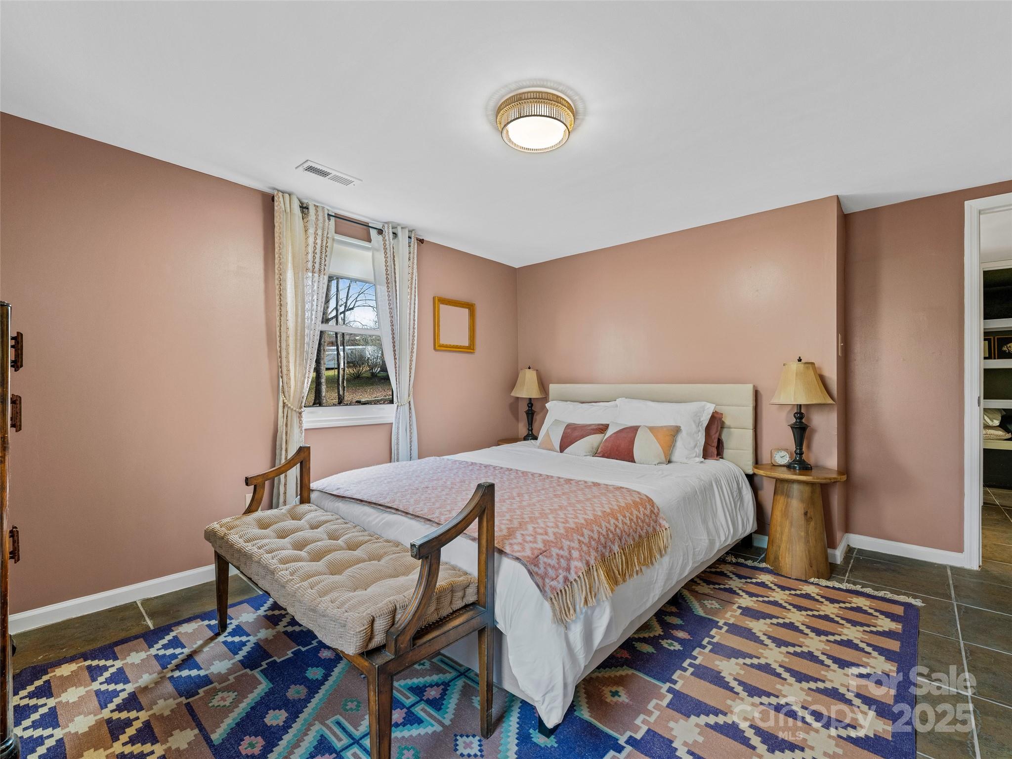 277 Markham Road Tryon, NC 28782 - Photo 35 of 44 a bedroom with a bed and wooden floor