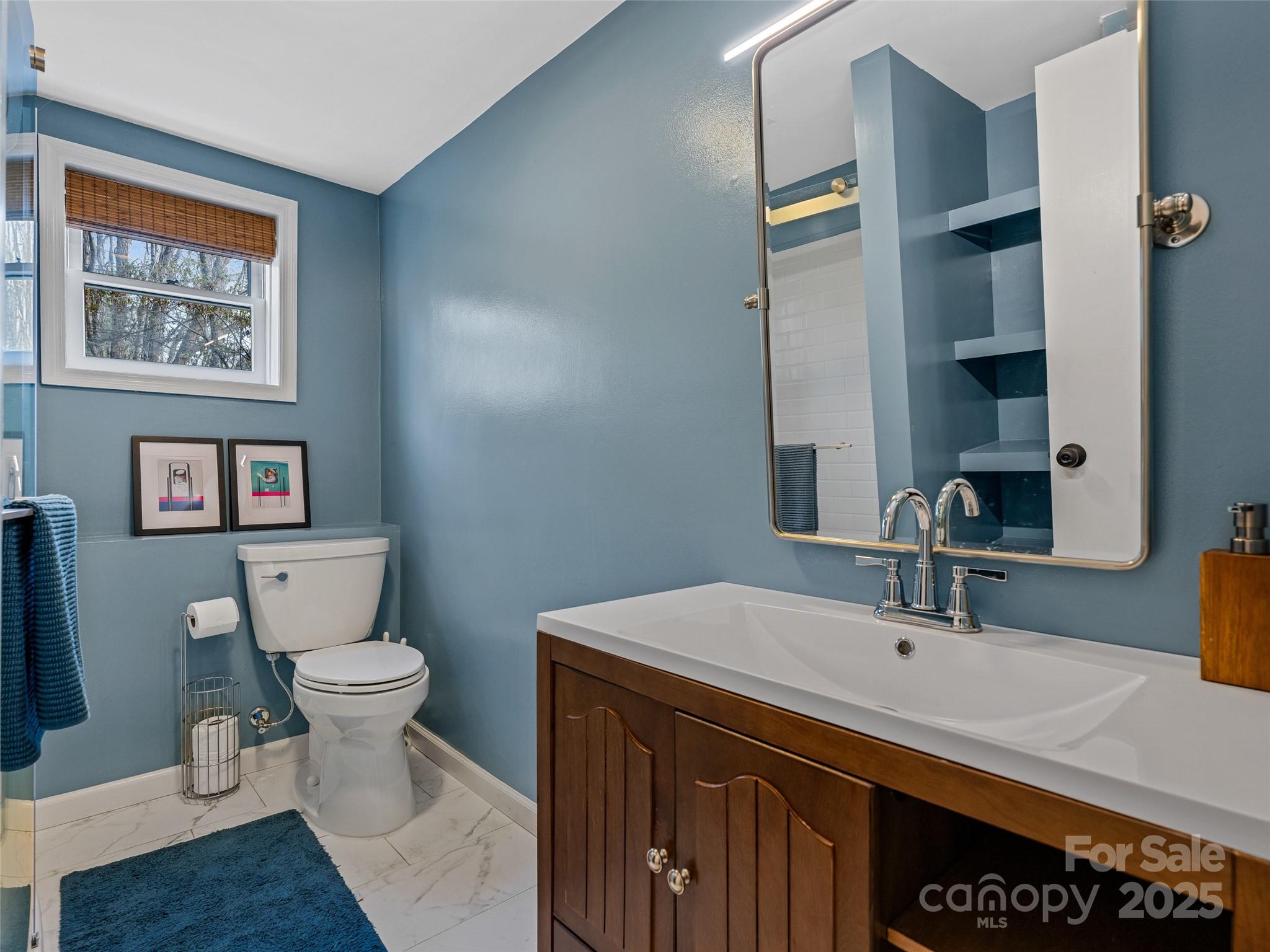 277 Markham Road Tryon, NC 28782 - Photo 37 of 44 a bathroom with a sink and a mirror