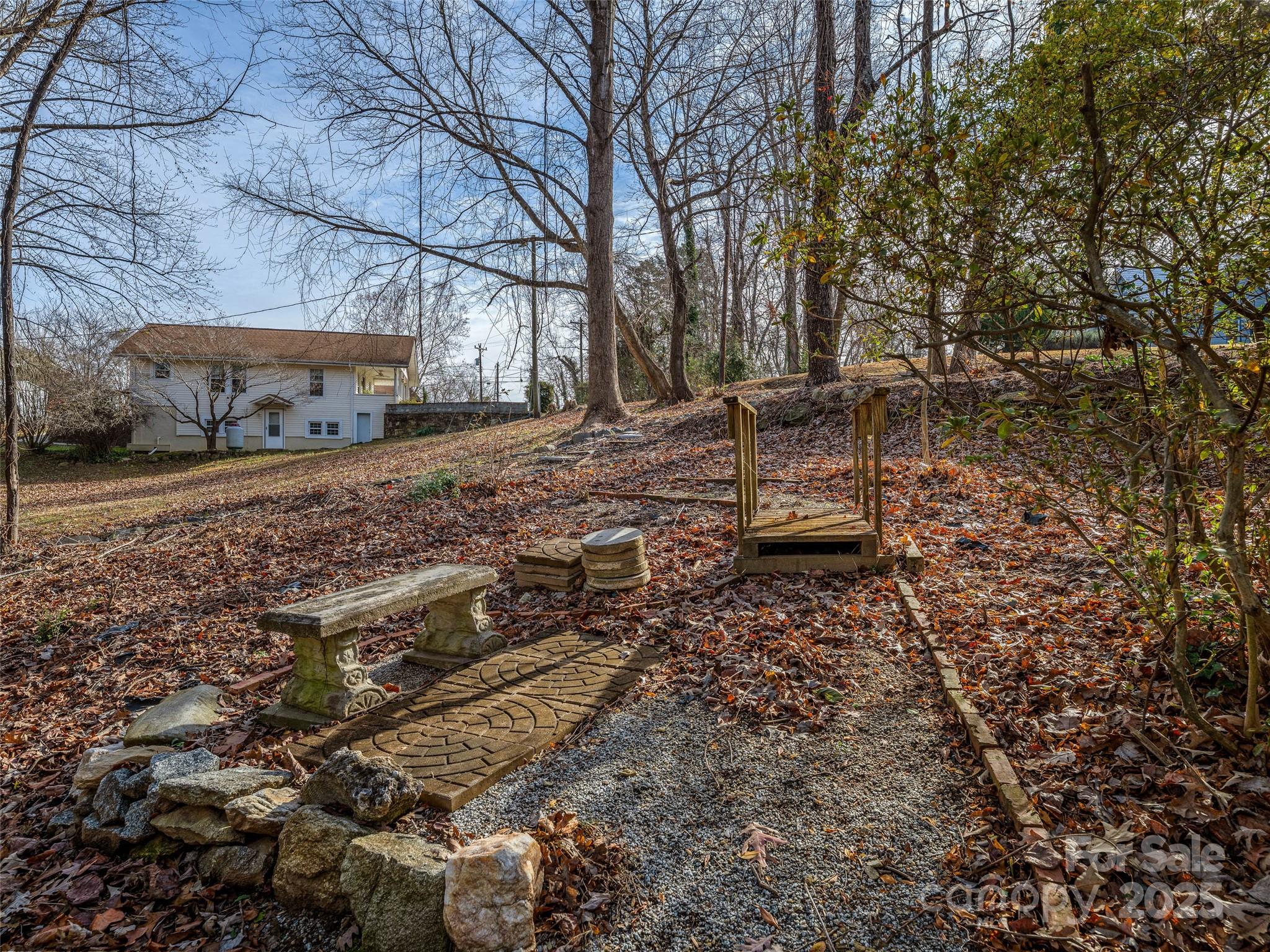 277 Markham Road Tryon, NC 28782 - Photo 39 of 44 a backyard of a house with barbeque oven table and chairs