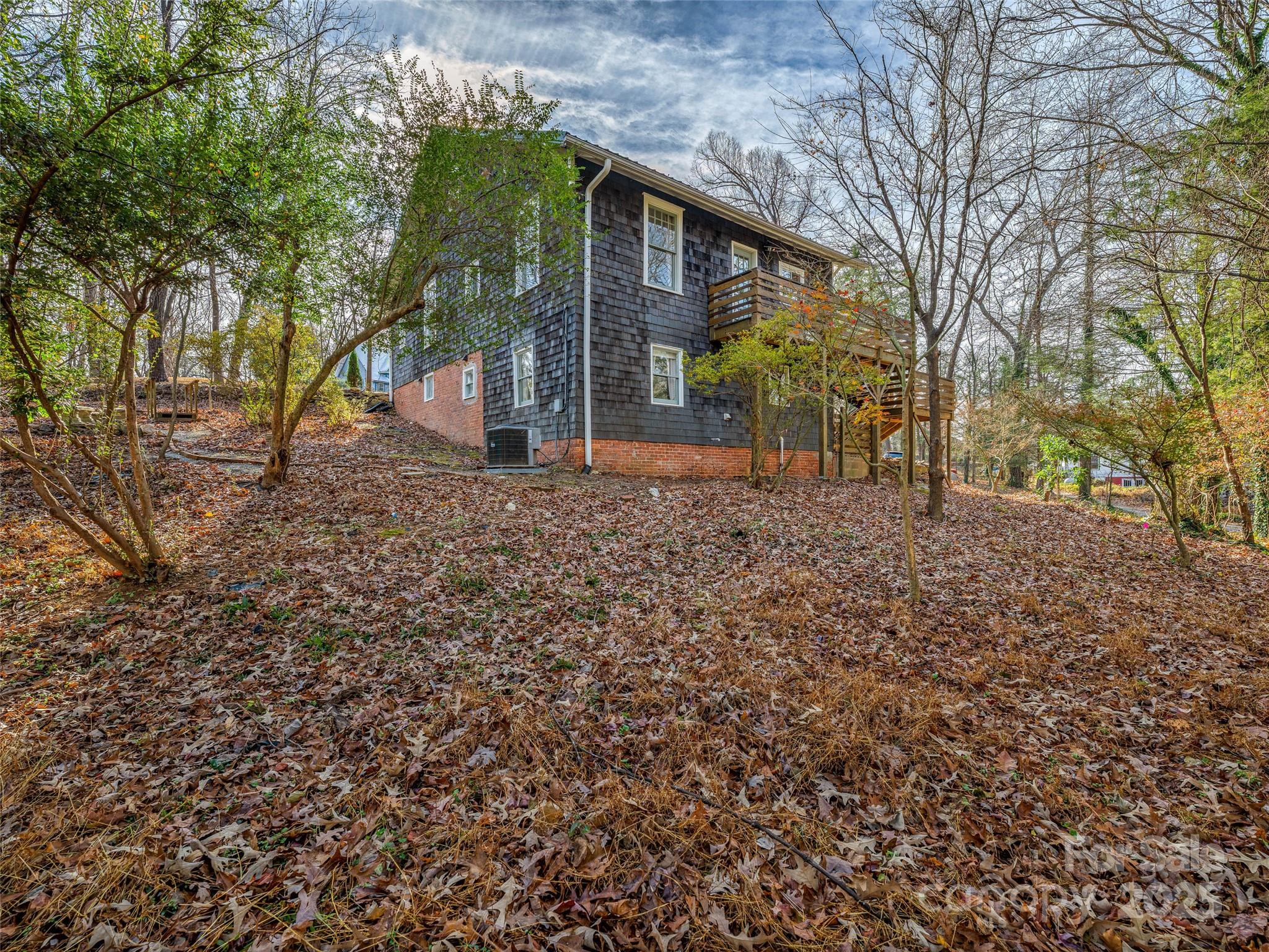 277 Markham Road Tryon, NC 28782 - Photo 43 of 44 a view of a house with a yard