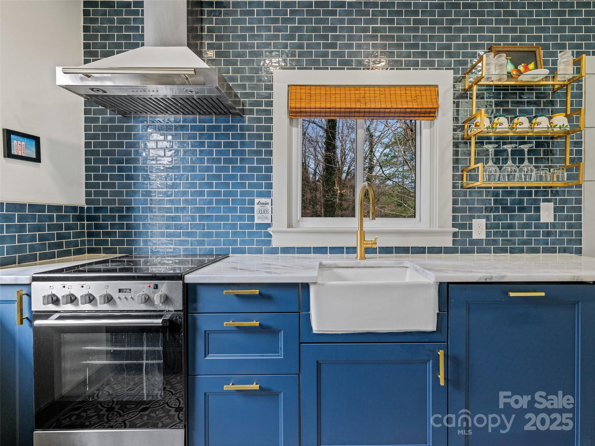 277 Markham Road Tryon, NC 28782 - Photo 5 of 44 a kitchen with a stove and cabinets