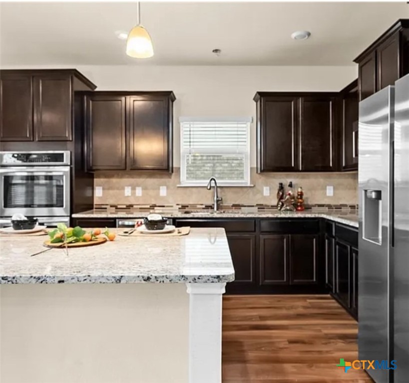 5561 Perdita Drive Belton, TX 76513 - Photo 11 of 24 a kitchen with a sink stove and refrigerator