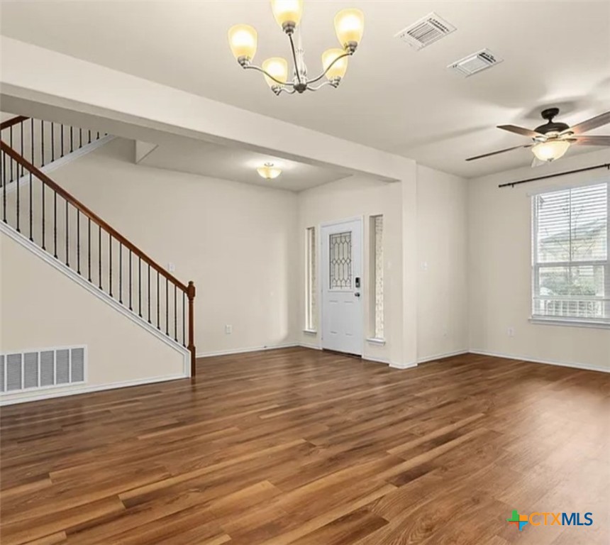 5561 Perdita Drive Belton, TX 76513 - Photo 3 of 24 a view of an empty room with wooden floor and a chandelier fan