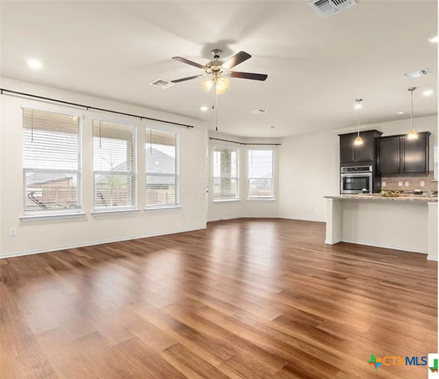 5561 Perdita Drive Belton, TX 76513 - Photo 5 of 24 a view of an empty room with a window and wooden floor