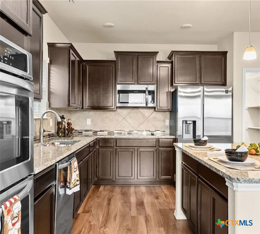 5561 Perdita Drive Belton, TX 76513 - Photo 8 of 24 a kitchen with stainless steel appliances granite countertop a sink stove and refrigerator