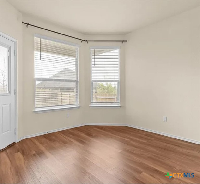 5561 Perdita Drive Belton, TX 76513 - Photo 10 of 24 a view of a room with wooden floor and windows