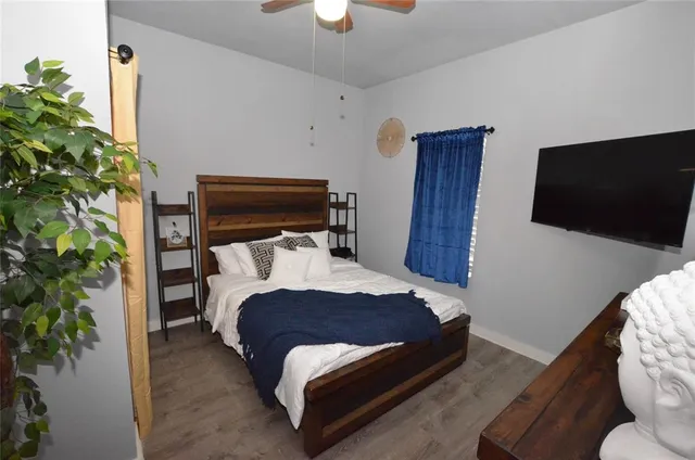 a bedroom with a bed and a potted plant