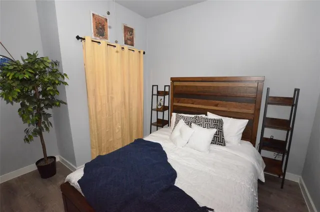 a bedroom with a bed closet and a potted plant