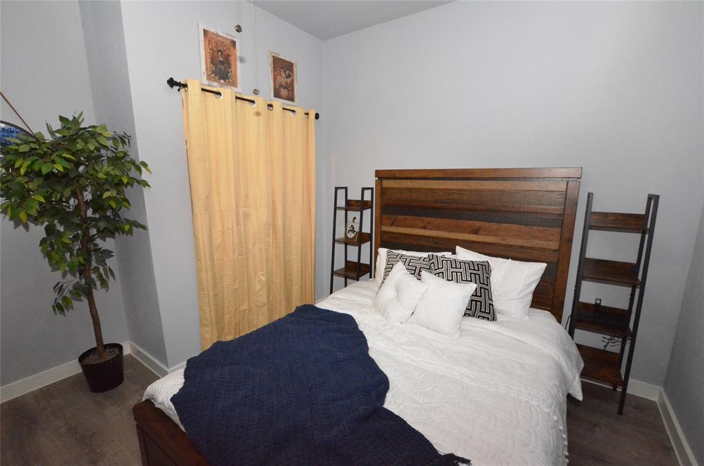 702 North Tennessee Street McKinney, TX 75069 - Photo 6 of 10 a bedroom with a bed closet and a potted plant