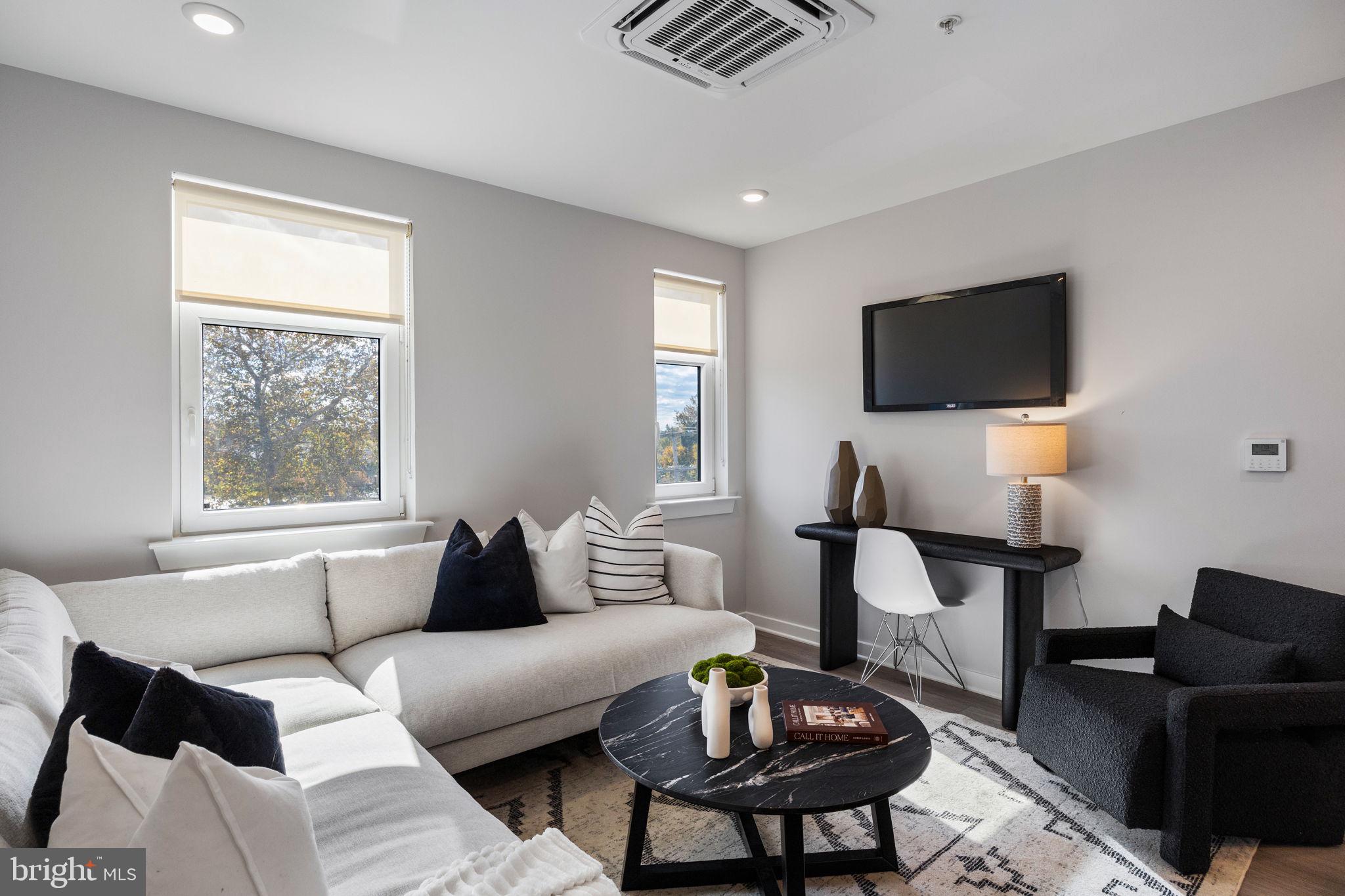 a living room with furniture and a flat screen tv