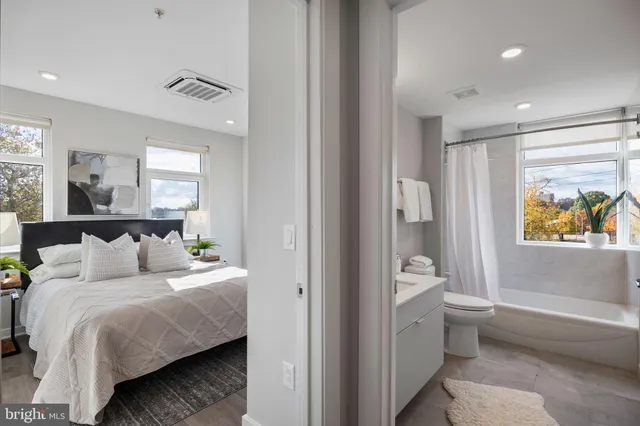 a bedroom with a bed and a painting on the wall