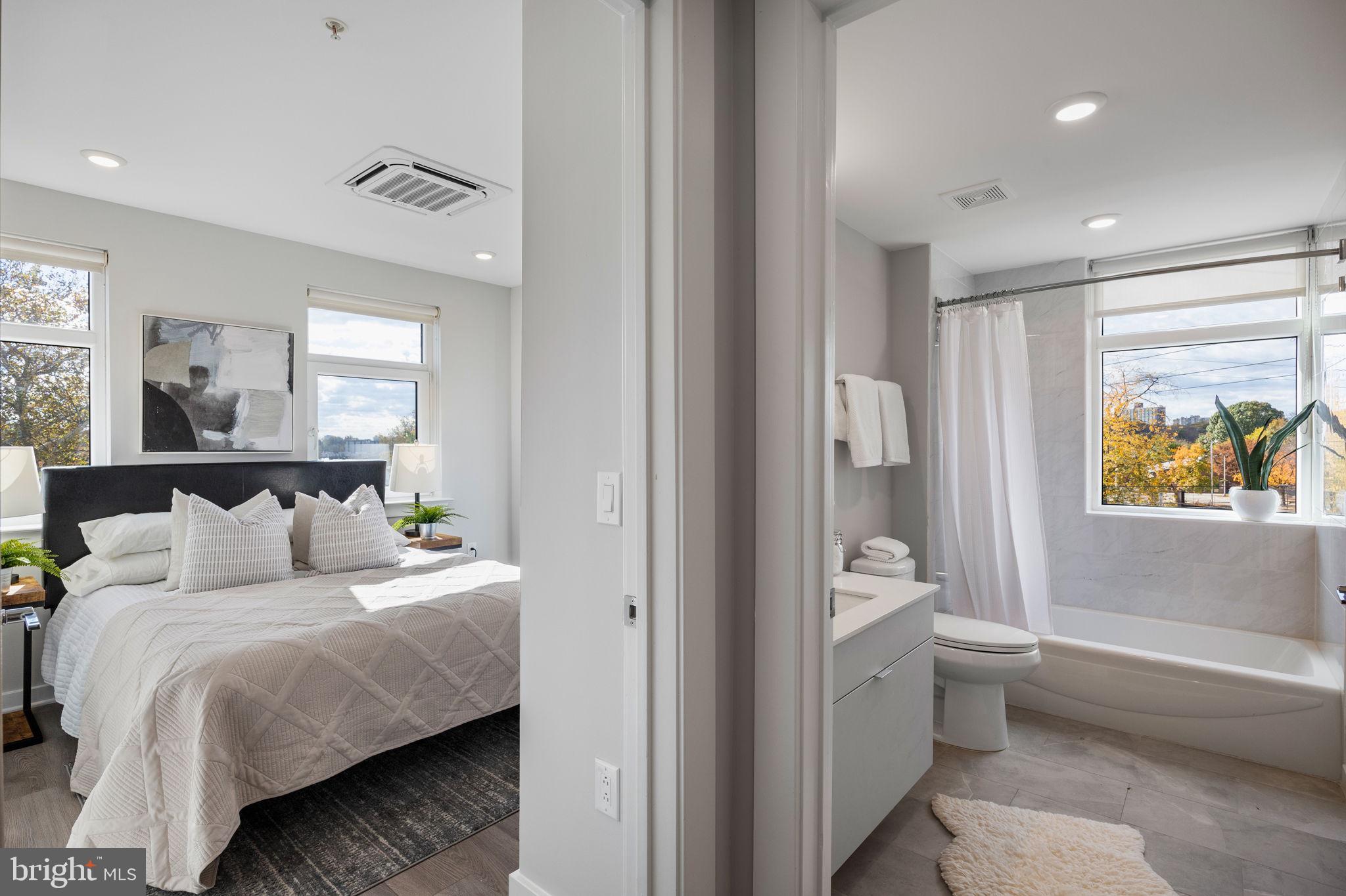 3449 Scotts Lane, Unit A320 Philadelphia, PA 19129 - Photo 17 of 35 a bedroom with a bed and a painting on the wall