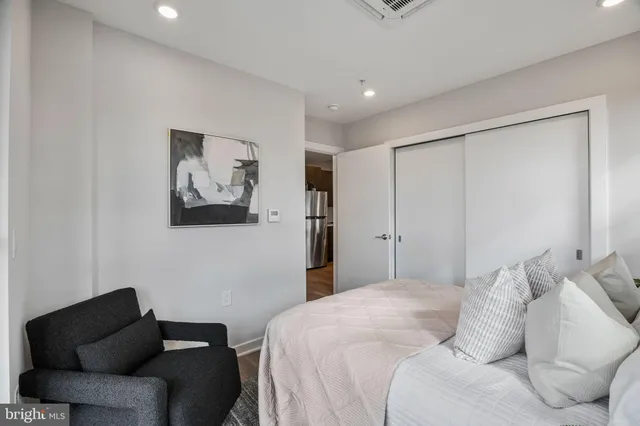 a bedroom with a bed and a couch