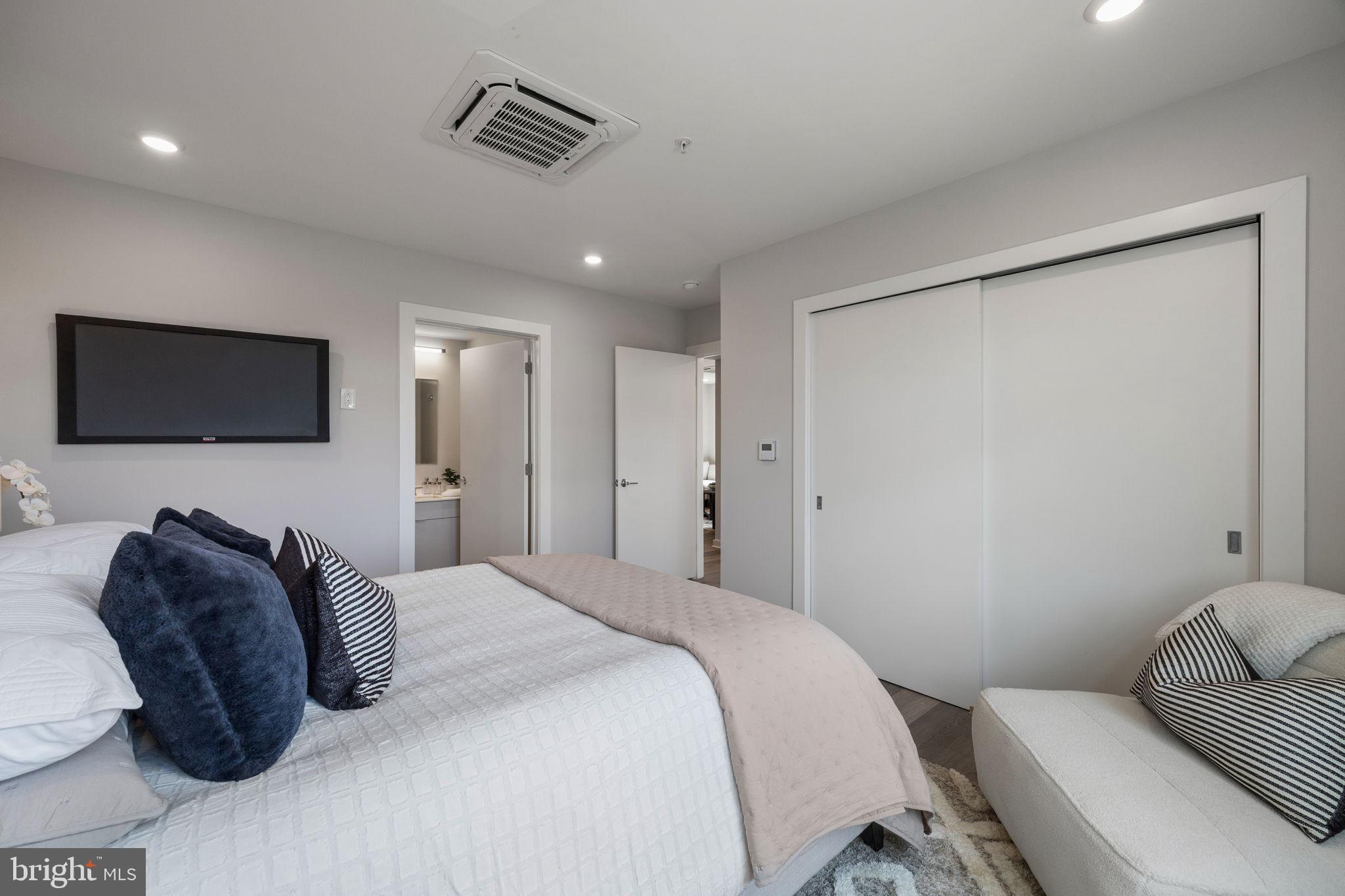 3449 Scotts Lane, Unit A320 Philadelphia, PA 19129 - Photo 28 of 35 a bedroom with a bed and a television