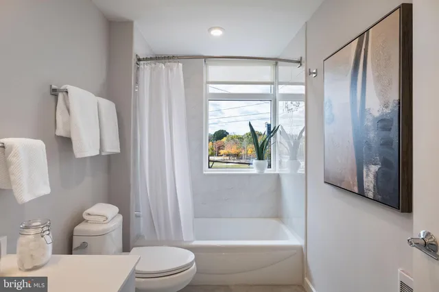 a bathroom with a toilet and a shower