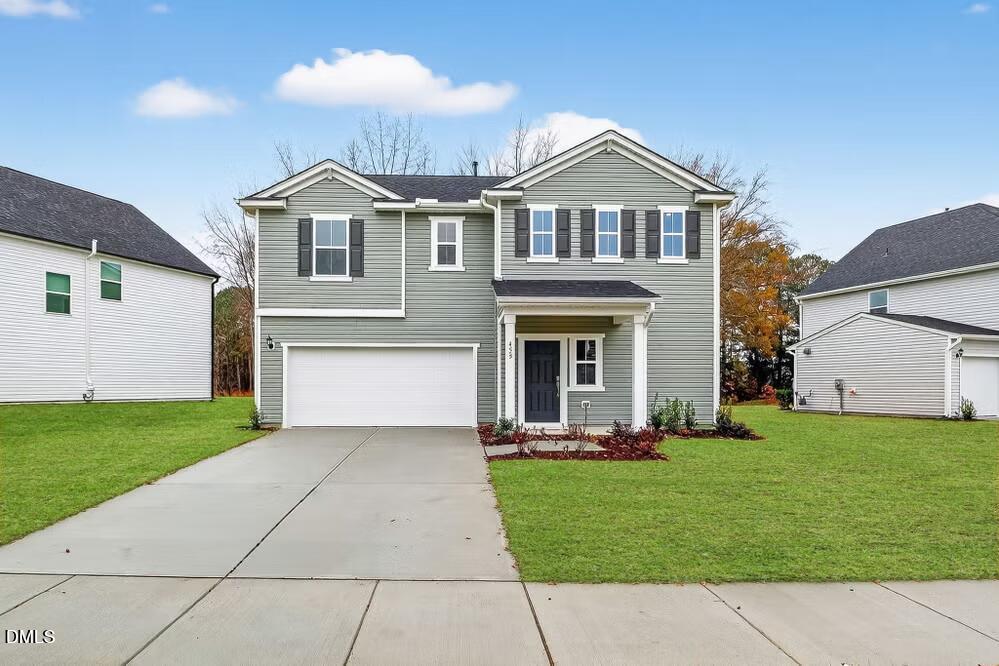 a front view of a house with a yard and garage