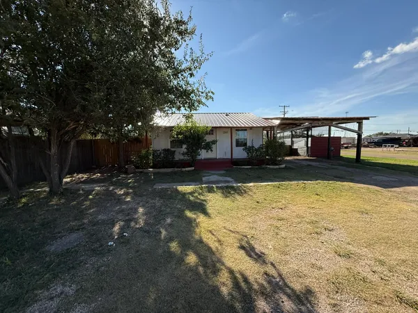 a view of swimming pool with seating area and trees in the background