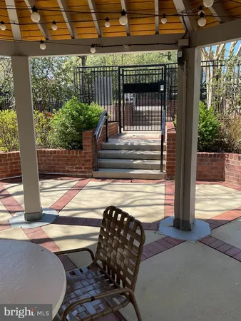a view of a patio with table and chairs with wooden floor and fence