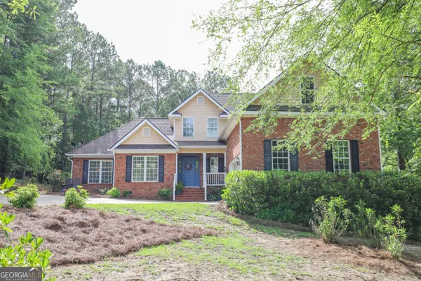 a front view of a house with a garden
