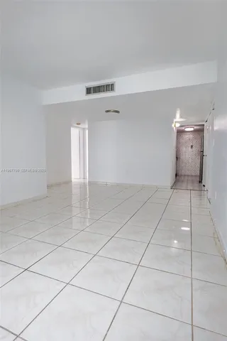 a view of a room with a projector and cabinets