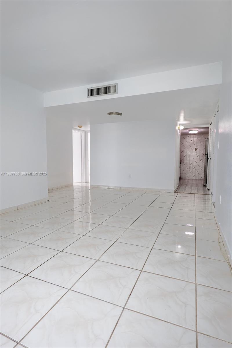 750 Northwest 43rd Avenue, Unit 308 Miami, FL 33126 - Photo 12 of 31 a view of a room with a projector and cabinets