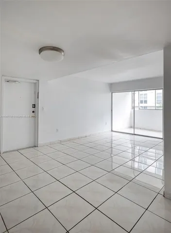 a view of a livingroom with wooden floor and window