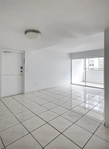 a view of a livingroom with wooden floor and window