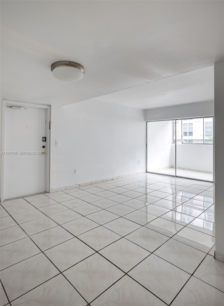750 Northwest 43rd Avenue, Unit 308 Miami, FL 33126 - Photo 13 of 31 a view of a livingroom with wooden floor and window